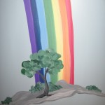 the rainbow ends behind a great tree
