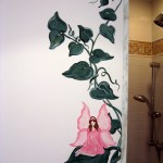 Here a fairy sits on a leaf of a vine hugging the entrance of a shower wall